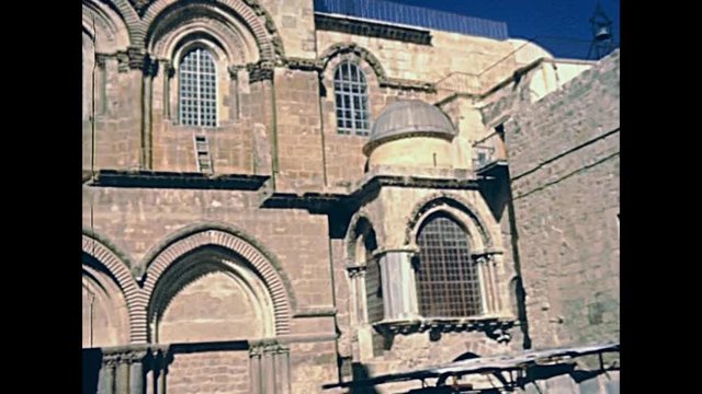 Church of the Holy Sepulchre in the Muristan area of the christian district. Old City of Jerusalem. Historic restored footage on 1980s in Israel.