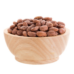 pinto beans  in a wooden bowl isolated on a white background.