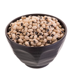 Black-eyed peas in a ceramic bowl isolated on a white background