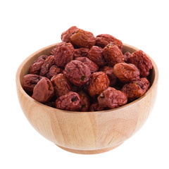 Dried jujube fruits in wooden bowl chinese herbal medicine on a white background