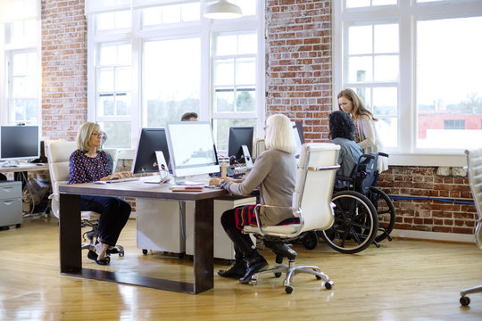 Business People Working At Desk In Office