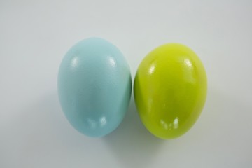 Blue and yellow Easter eggs on white background