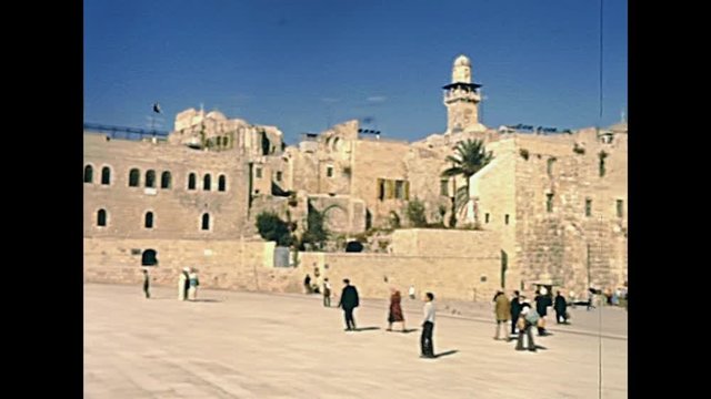 Panorama of the Western Wall Plaza in old city of Jerusalem with people. Historic restored footage on 1980s in Israel.