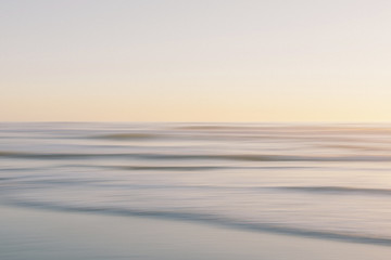 Scenic view of seascape against clear sky during sunset