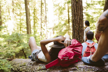 Friends relaxing in forest