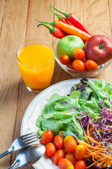 Healthy concept with mixed fruits and vegetables on wooden background