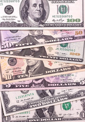 Abstract dollar bills of different denominations background.