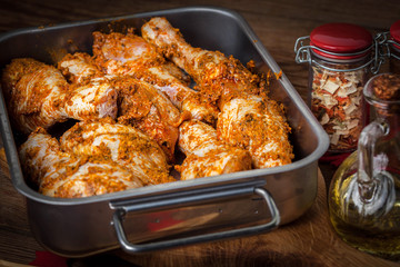 Marinated chicken drumsticks ready for baking.