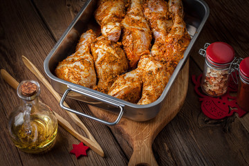 Marinated chicken drumsticks ready for baking.