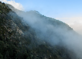 The fog goes up covering the mountains