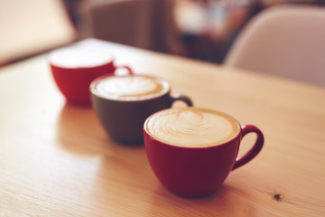 Three cups of cappuccino on the table