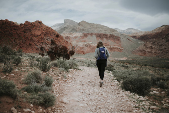 Rear view of hiker with backpack walking at Red Rock Canyon National Conservation Area
