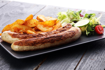 grilled sausages and potatoes and salad