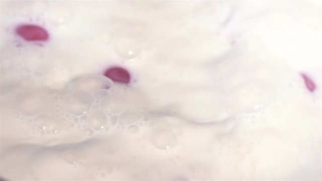 High quality video of cherry tomatoes falling into milk in real 1080p slow motion 250fps