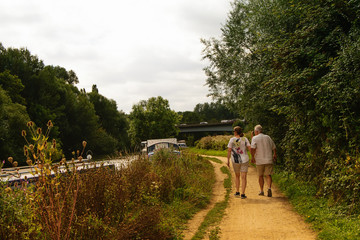 Countryside landscape and a couple walking along the river