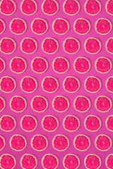 Grapefruit pattern on pink background. Minimal flat lay concept.