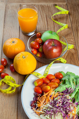 Healthy concept with mixed fruits and vegetables on wooden background