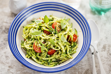 Spiralled courgette spaghetti with green pesto and cherry tomatoes 