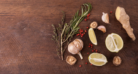 Fototapeta na wymiar Garlic, spices and herbs on the wooden background. Top view, copy space for text