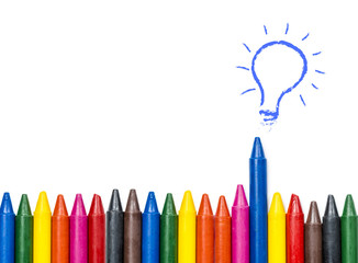 idea can make the different concept , colorful oil pastel crayons and light bulb idea on white...