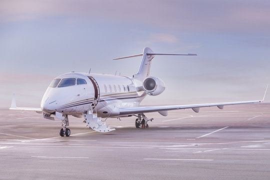 Fototapeta Private jet plane parking at the airport. Private airplane at sunset,