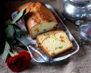Cake with candied fruits and raisins on an old wooden background. Rustic style.
