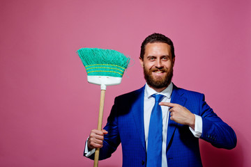 business and home, handsome happy man or businessman with broom