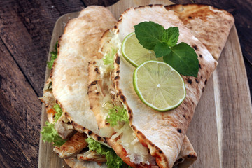 Delicious kebab sandwiches on wooden table