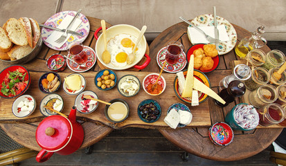 Rich and delicious Turkish breakfast on a round table - obrazy, fototapety, plakaty