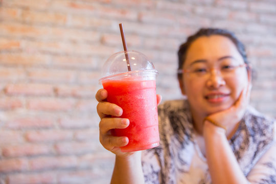 Fatty women tubby drinking fruit smoothie fruit healthy drink good for diet and cool ice for hot day in summer season.