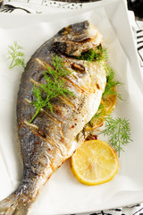 Dorado stuffed with lemons and greens.