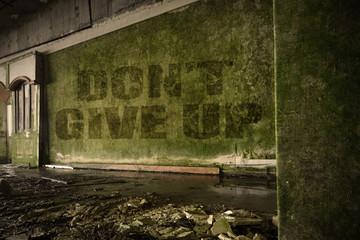text dont give up on the dirty wall in an abandoned ruined house