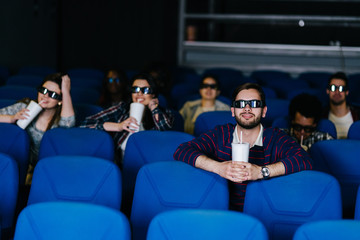 Young man enjoying a 3D movie alone at the cinema