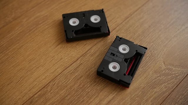 Mini DV cassettes falling on the floor, slow motion.