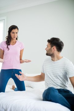 Couple arguing with each other in bedroom