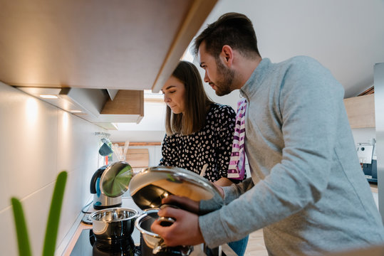 Beautiful young couple in the kitchen together