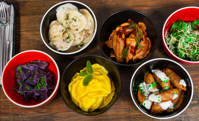 Set of different dumplings and ravioli on a wooden table