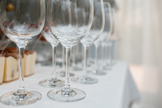 Close up picture of empty glasses on the beige tablecloth  in restaurant