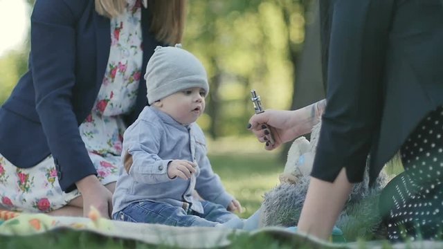 The woman demonstrate the vape to little boy