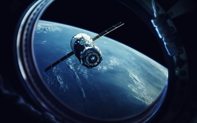 View from spaceship porthole. Earth and spacecraft. Elements of this image furnished by NASA - obrazy, fototapety, plakaty