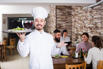 professional male cook showing country restaurant