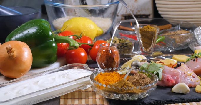 Dolly view of ingredients and indian spices for chicken tikka masala