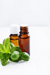 Basil essential oils in dark bottles, free text space.