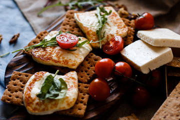 Cute little girl enjoying a homemade cooking holding a slice in her hand as she sits at the table looking at the camera with a smile