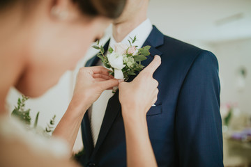 flowers on the jacket of a groom
