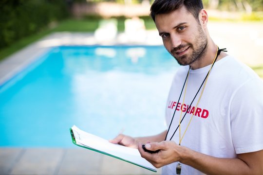 Lifeguard holding clipboard and stopwatch 