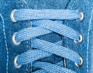 Denim sneakers close-up macro texture isolated on white background