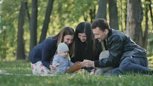 Swedish family relaxing in park with little son