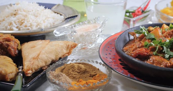 Dolly view of a delicious chicken tikka masala with Indian spices