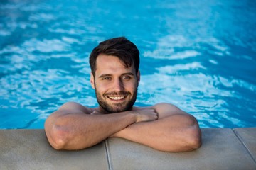 Portrait of young man relaxing in the pool